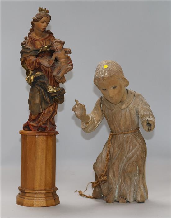 An 18th century Tyrolean carved pine figure of a monk, left hand deficient, and one other, H.40cm